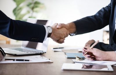 business-people-shaking-hands-together (1)-min (1)