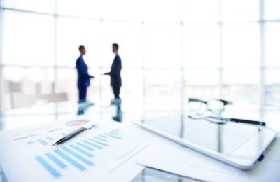 documents-with-charts-touchpad-desk-min